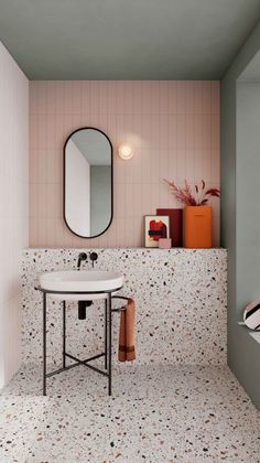 a white sink sitting under a mirror in a bathroom next to a wall mounted faucet