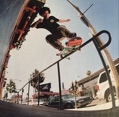 a man riding a skateboard up the side of a metal rail