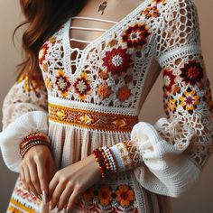 a woman wearing a white crochet dress and bracelets