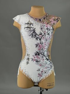 a woman's white leotard with pink flowers on it