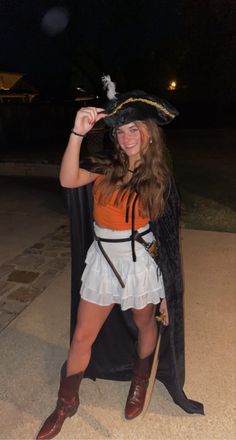 a woman dressed as a pirate posing for the camera