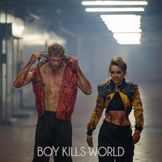 a man and woman walking down a street with the words boy kills world on it