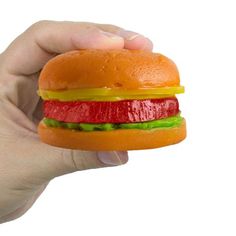 a hand holding a toy hamburger in it's palm