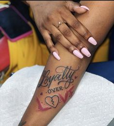 a woman's arm with tattoos on it that says beauty over love and hearts