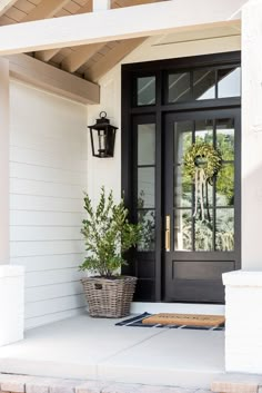 a black front door on a white house