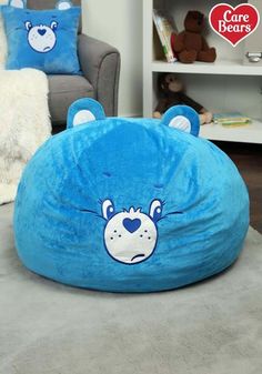 a blue bear bean bag chair sitting on top of a gray rug in a living room