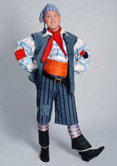 a man dressed in pirate costume posing for the camera with his hands on his hips