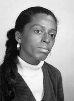 a black and white photo of a woman with braids