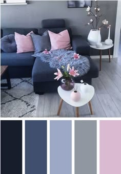 a living room with blue couches and pink pillows in the center, along with gray walls