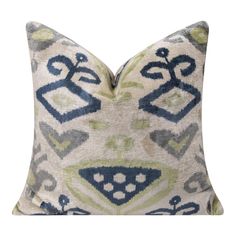 a blue and green pillow with an ornate design on the front, sitting on a white background