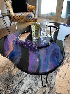 a glass table with purple and blue designs on it