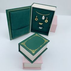 an open book with a face on the front and two necklaces in the back