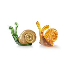 two glass snails sitting next to each other