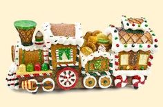 a christmas train ornament with gingerbreads and other treats on the side