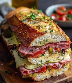 a ham and cheese sandwich on a wooden cutting board