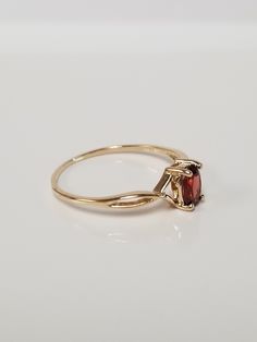 "Thanks for shopping our vintage estate store. We tend to sell well below wholesale and truly hope you enjoy all of our items. Many of the items are one of a kind, so please enjoy scrolling through the pictures and hopefully something will catch your eye. Brown spots are from reflections. Estate 14k yellow gold natural .50ct garnet midi or birthstone ring. Ring size: 7 Setting: 6mm by 4mm 1/4\" Band width: 1mm Weight: 1.14 grams Beautiful ring. Marked 14k." Classic Diamond Ring With Birthstone In Round Band, Classic Ruby Birthstone Ring With Round Band, Classic Birthstone Ring With Round Band, Classic Round Band Birthstone Ring, Classic Birthstone Ring, Classic Round Ruby Birthstone Ring, Classic Oval Ruby Ring In Yellow Gold, Classic Pear-shaped Gemstone Rings, Classic Pear-shaped Ring For Gift