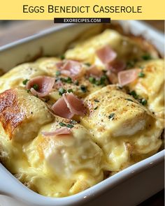 an egg benedict casserole in a white dish with ham and cheese on top