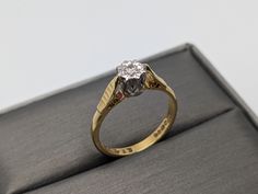 a diamond ring sitting on top of a box