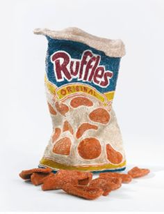 a bag of ruffles sitting on top of a pile of orange peels