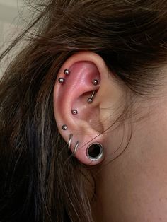 a woman with some piercings on her ear