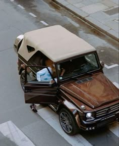 an overhead view of a car with the hood open and two people sitting in it