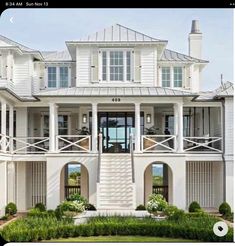 a large white house with lots of windows and balconies on the second floor