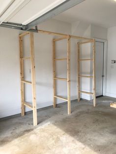 an empty room with three wooden ladders in it