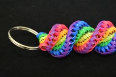 several different colored bracelets on a metal hook