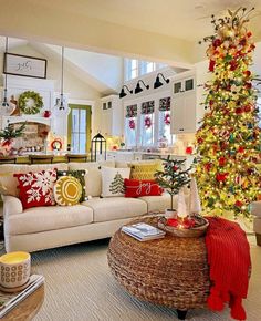 a living room filled with furniture and a christmas tree in the middle of the room