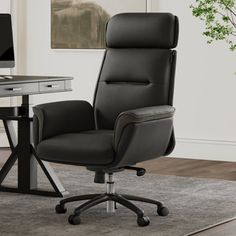 a black office chair sitting in front of a desk with a computer monitor on it