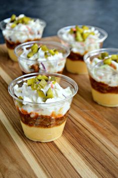 small cups filled with food sitting on top of a wooden table