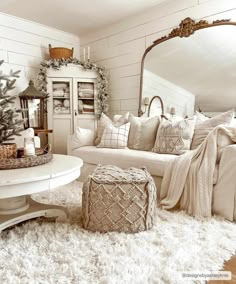 a living room filled with furniture and a christmas tree in the corner near a mirror