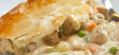 a close up of a pie with chicken and vegetables