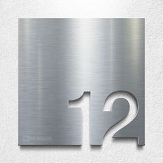 a metal sign with the number twelve on it