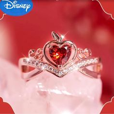 a heart shaped ring with diamonds on top