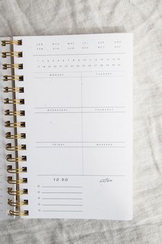 an open planner with gold lines on it