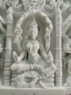 an intricately carved white statue on display