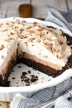 a chocolate pie with white frosting and chopped nuts