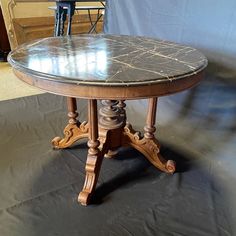 Beautiful dark gray Carrara marble French dining table or center accent table with lovely veining on the top of the exquisitely beveled round table top. Intricate turned walnut base allow this versatile table to be either a dining table comfortably seating 4 - 6, or the table can also serve as a beautiful entry table that will add elegance to any home. #6501 apron 26.75 h Marble Top Table Antique, French Dining Table, Round Wood Table, French Dining Tables, Table With Marble Top, Table With Marble, Circle Table, Round Table Top, Marble Table Top