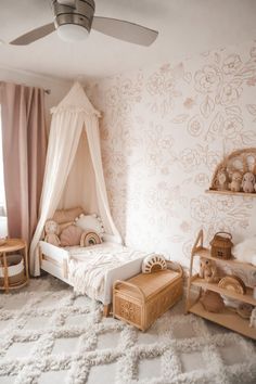 a child's bedroom with a canopy bed and white rugs on the floor