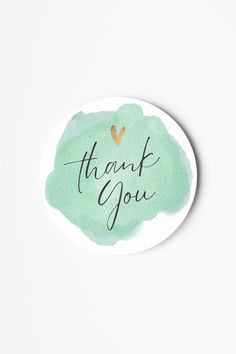 a green watercolor circle with the words thank you written on it