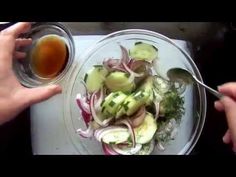 someone is holding a spoon over a plate of food with onions and broccoli