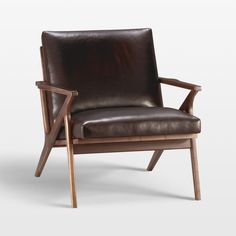 a brown leather chair sitting on top of a wooden frame