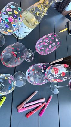 several wine glasses and pencils on a table