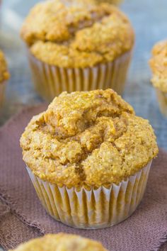 a muffin sitting on top of a cloth next to other muffins