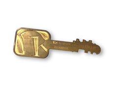 a gold key with the letter k on it's side and two keys attached to it