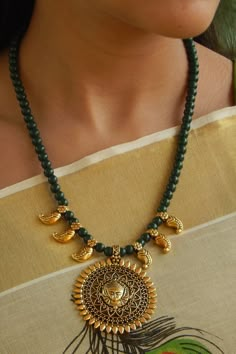 Product Features:   Material: Alloy Color: Gold and Dark Green Type of Work: Beads Pendant Type: Oxidized Gold Goddess Durga Pendant Necklace Length (Without Dori): 44 Cm Dori Length: 26 Cm Pendant Height:  5.8 Cm Pendant Width: 5 Cm Occasion: Traditional Disclaimer: Color and Texture may have slight variation due to photography Gold And Dark Green, Gold Goddess, Black Beads Mangalsutra Design, Choker Necklace Designs, Antique Jewellery Designs