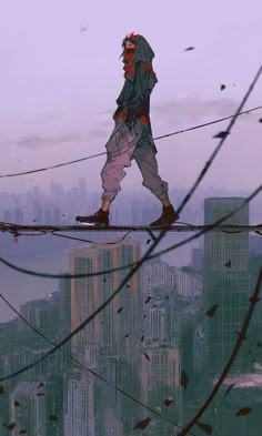 a man walking across a high wire over a cityscape with tall buildings in the background