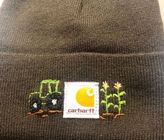 a beanie hat with an embroidered patch on the front and side of it that says, carhart