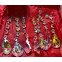 several pieces of jewelry sitting on top of a red cloth